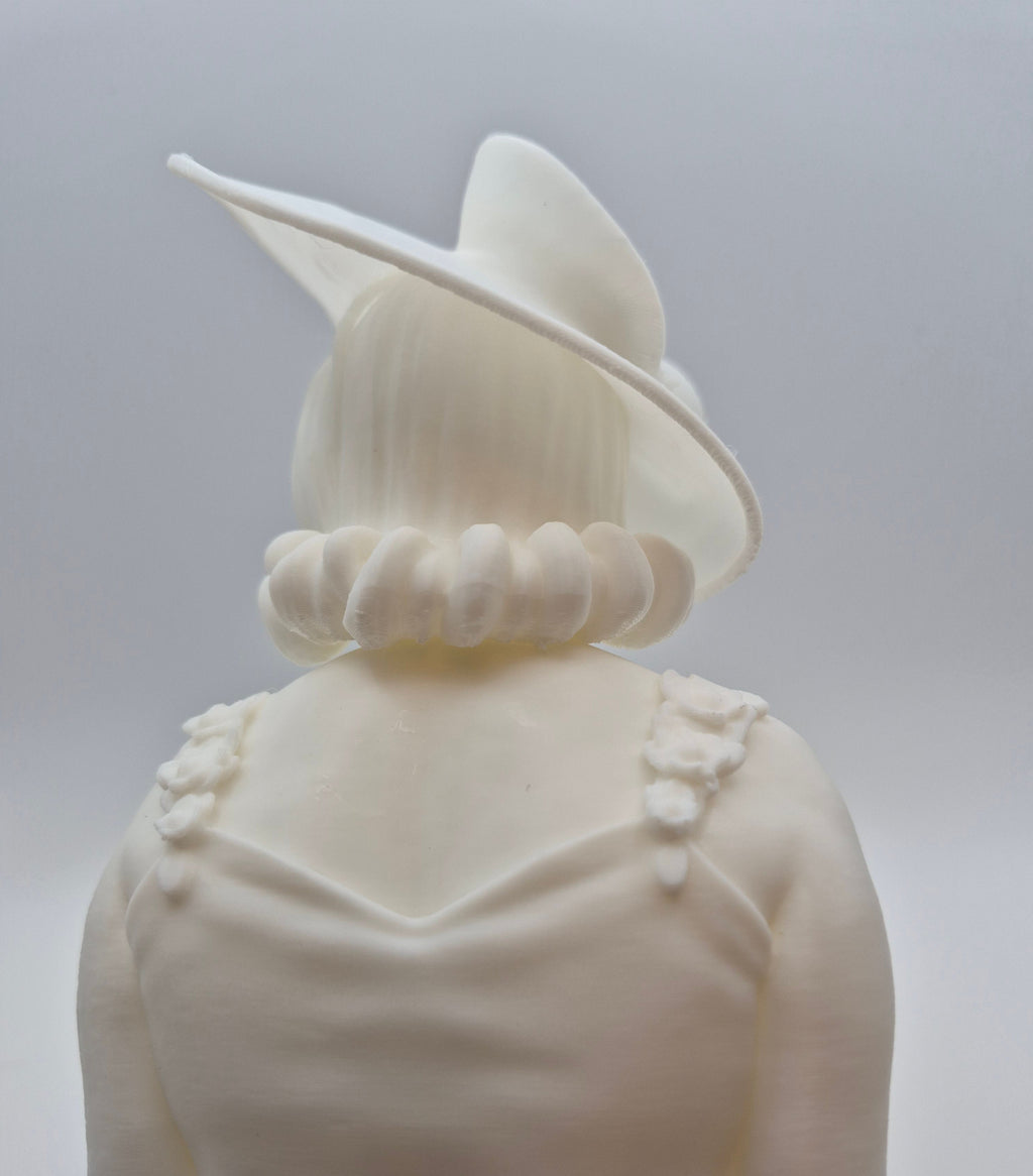 White ceramic bust of a person wearing a hat on a plain background