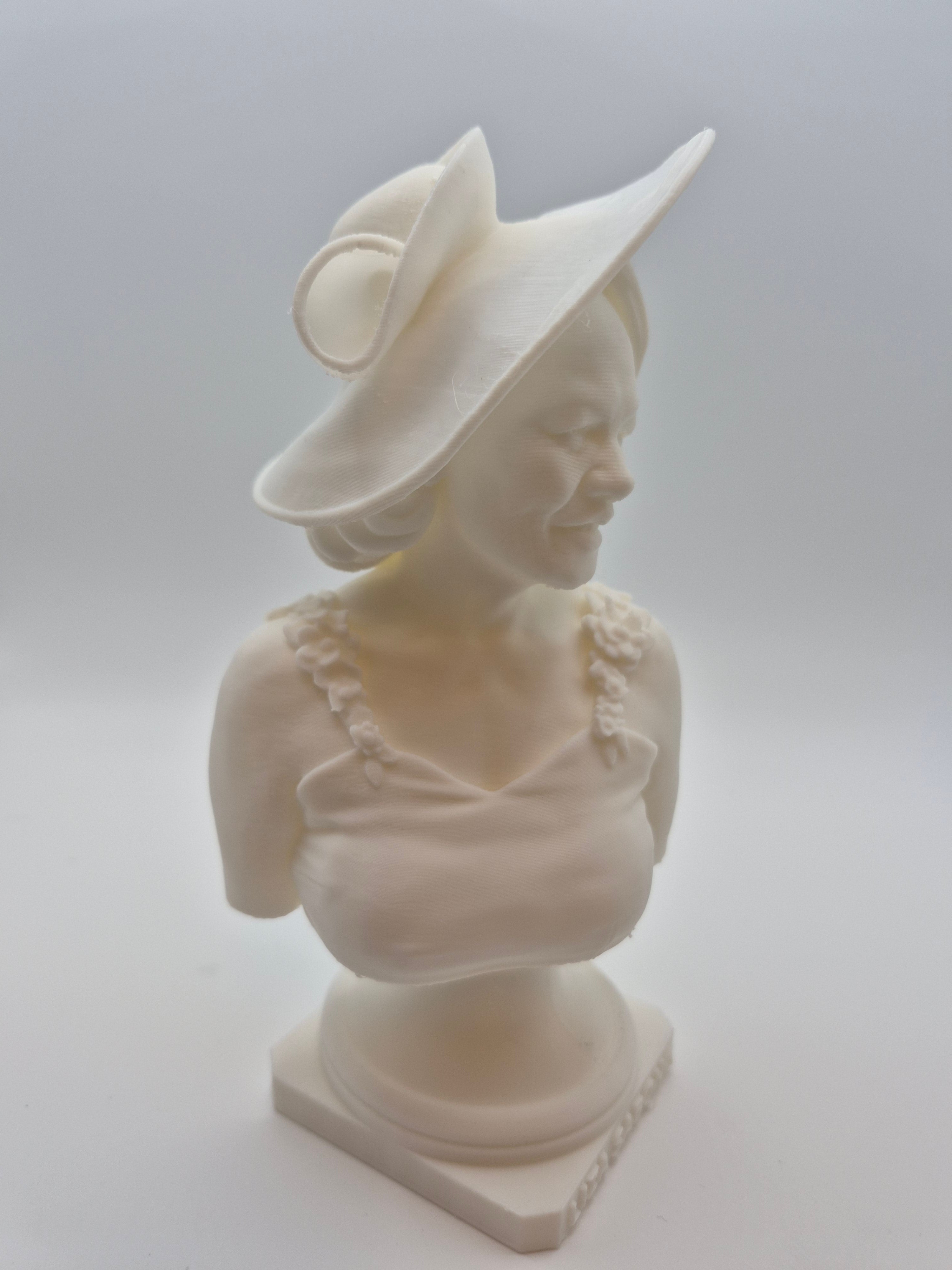 White sculpture of a classical figure on a plain background